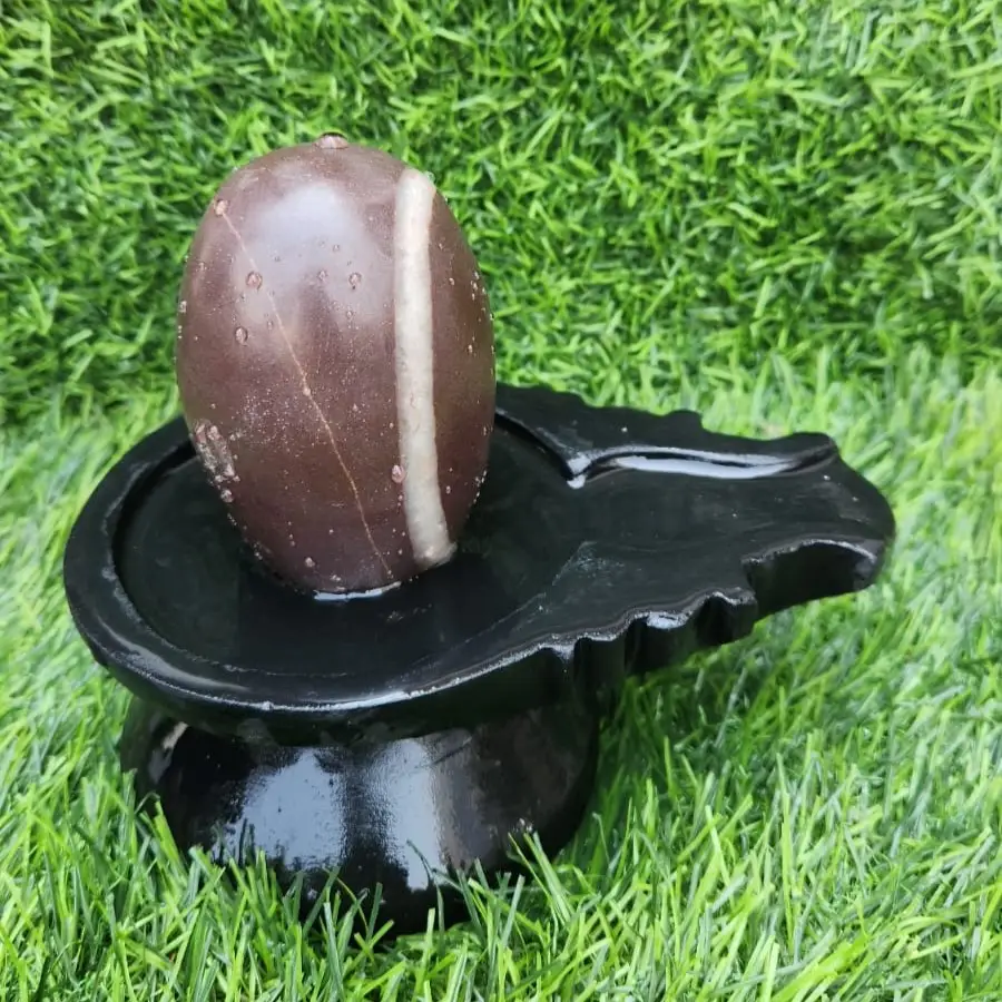 brown-stone-shivling-with-damru-narmada-shivling Smooth finish Narmada River Shivling – Energized and certified Shivling with Stone Base